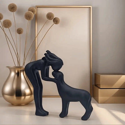 Black minimalist sculpture of a human and a dog. Freeze the moment of embrace, a declaration of eternal companionship dedicated to you.
